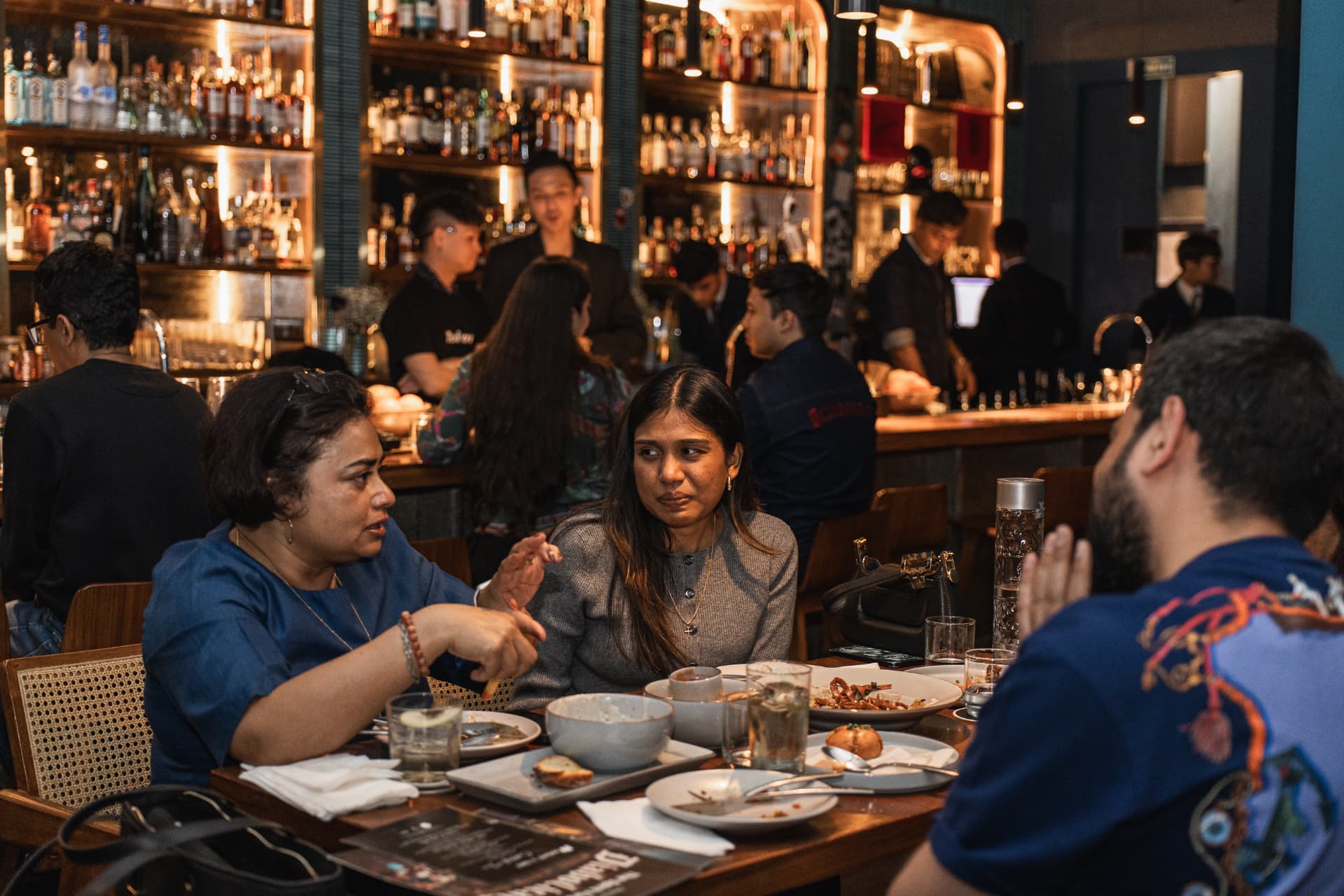 Guests sharing plates at the bar counter