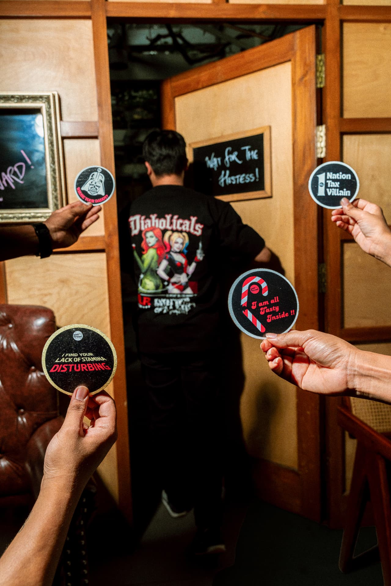 Diabolicals coasters held up at the bar door