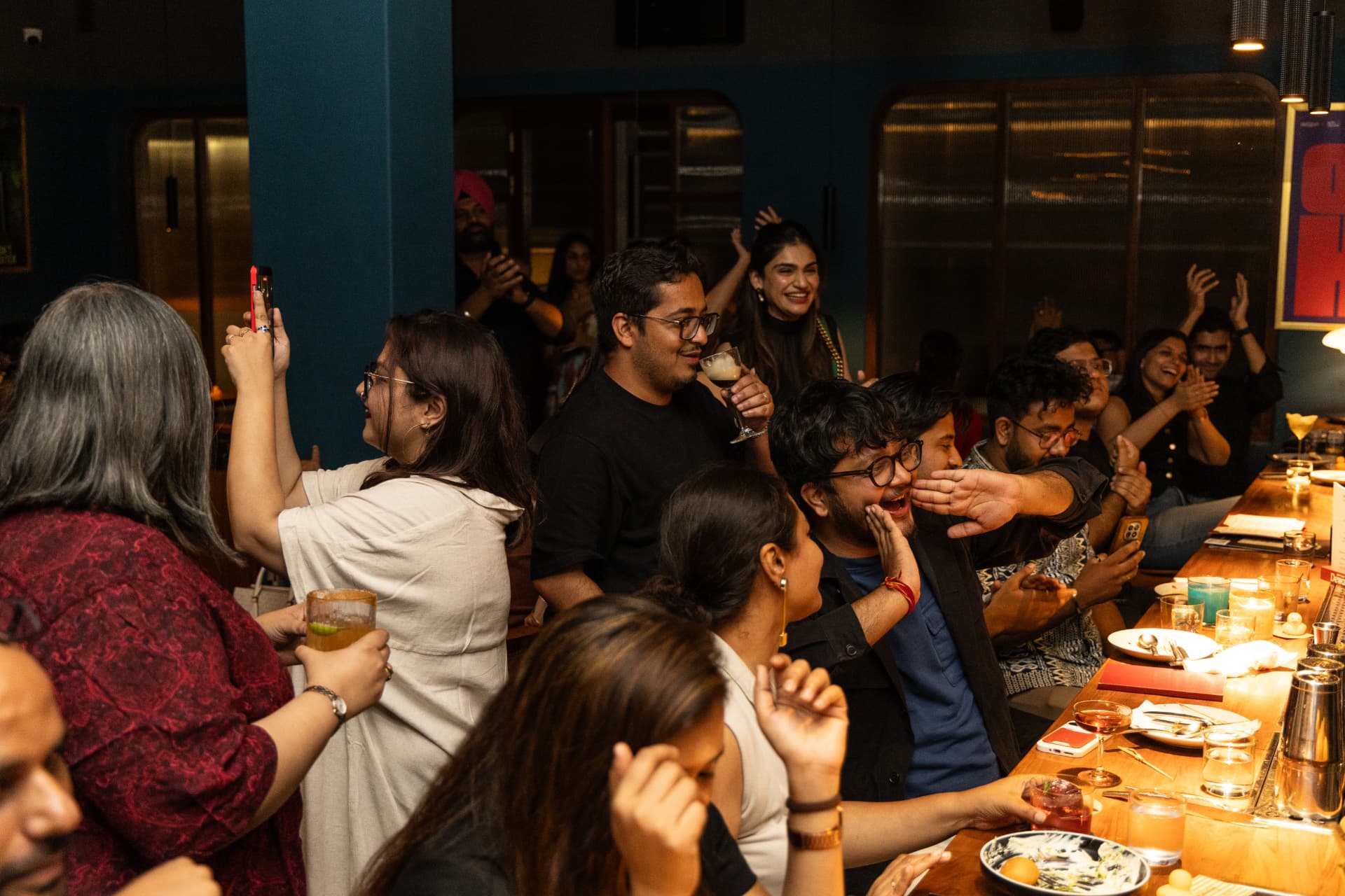 Guests cheering along the bar counter